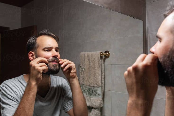 Adult Man Twisting Mustache In Morning by Stocksy Contributor Milles Studio